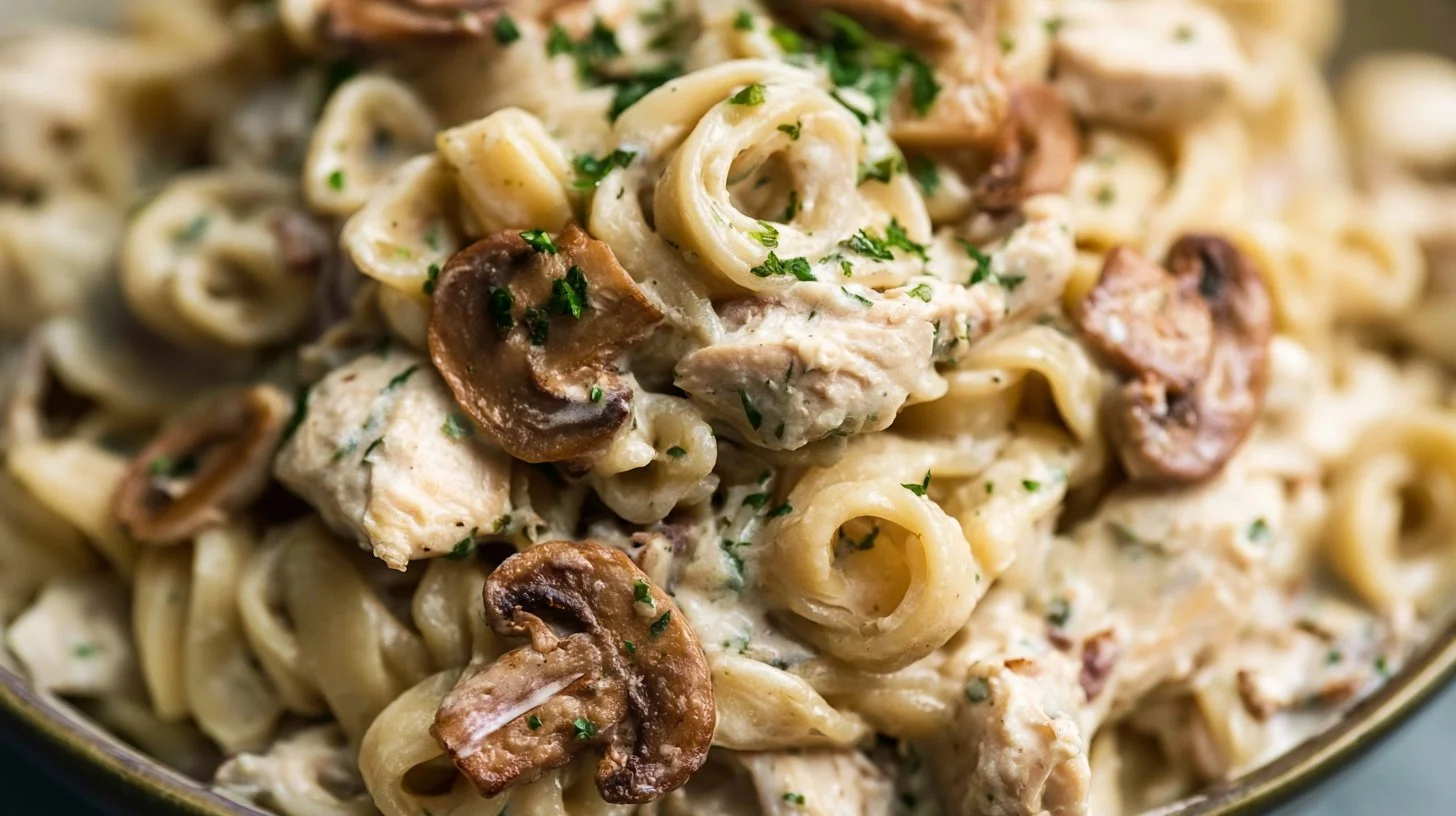 Creamy chicken and mushroom pasta garnished with fresh herbs